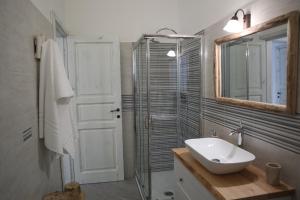a bathroom with a sink and a shower and a mirror at Il Fiore Bianco in Capo dʼOrlando +35 photos