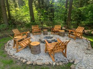 a group of wooden chairs sitting around a fire pit at Guest Rooms- KLEPALSKI House in Borovets