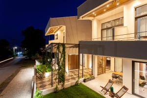 a house with a glass facade at night at aella apartments in Nikiti