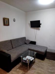 a living room with a couch and a tv at Lara in Doboj