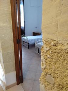 A bed or beds in a room at Regina Elena Casa Vacanze Salento