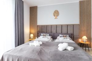 Posteľ alebo postele v izbe v ubytovaní Apartament Tatry55