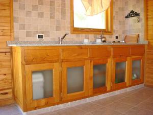a kitchen with a counter with a sink at Apart Hotel Altos de Antilhue in Villa La Angostura