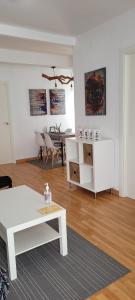 a living room with a white table and a couch at Apartamento Catalina, en el casco histórico. in Ronda +13 photos