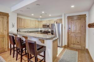 a kitchen with a large island with bar stools at Two-Bedroom Apartment in Edwards