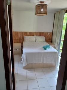 a bedroom with a bed in a room with a window at Bangalô duplex à beira-mar in Camaçari +23 photos