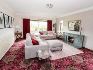 a living room with two couches and a fireplace at Dale View in Cockermouth