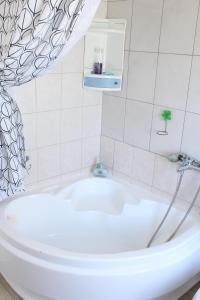 a white tub in a bathroom with a sink at Davanti al Mare in Epanomi +34 photos