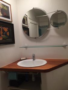 a bathroom with a sink and a mirror at Appartement près de DOLE in Menotey