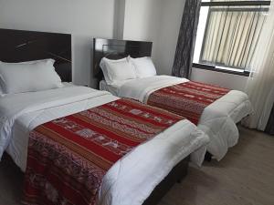 Hostal Killaly Inn Cusco客房内的一张或多张床位