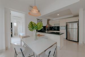 a kitchen with a table with a vase on it at Lumina at Palms Punta Cana Village in Punta Cana