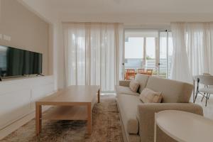 a living room with a couch and a table at Lumina at Palms Punta Cana Village in Punta Cana