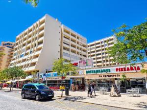 a car parked in front of a building on a street at Apartment Rocha Varandas Sunny in Portimão