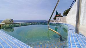 a swimming pool with a hose in the water at La Dea del Mare in Ischia
