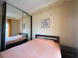 a bedroom with a bed and a mirror at Apartment SeaView in Bar