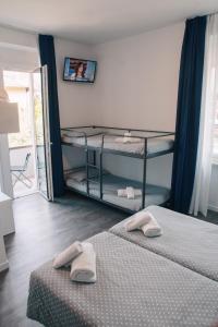 Voodi või voodid majutusasutuse Hotel Aurora & Appartamenti toas