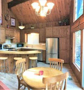 a kitchen with a table and chairs and a refrigerator at Klamath - V057 Cabin in Lake Arrowhead