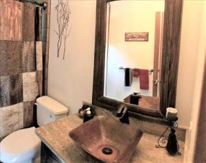 a bathroom with a sink and a toilet and a mirror at Klamath - V057 Cabin in Lake Arrowhead +23 photos