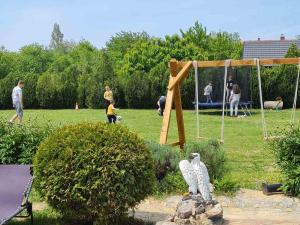 a group of people in a park with people playing at Apartmani Neven in Irig