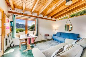 a living room with a blue couch and a table at Deep Water Cabin in Hollywood Beach