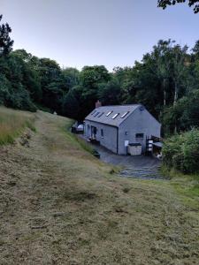 a large white building in the middle of a field at Best Beach 2025 "Little Haven" & The Hidden Gem in Haverfordwest
