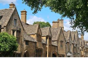 a row of old stone houses with chimneys at Entire apartment, 10mins from Cotswolds, Child friendly, Great Location & plenty of free parking nearby in Evesham