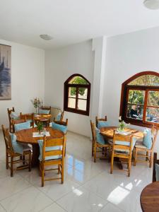uma sala de jantar com mesas e cadeiras de madeira em Candia Hotel em Chania