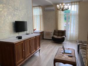 a living room with a tv and a couch at House NAG in Kutaisi