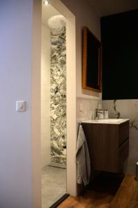een badkamer met een wastafel en een spiegel bij Bed and Breakfast in de buurt in Waalwijk