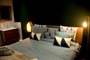 a bedroom with a bed with pillows on it at Bed and Breakfast in de buurt in Waalwijk