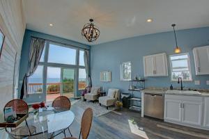 a kitchen and living room with a view of the ocean at The Lighthouse in Homer