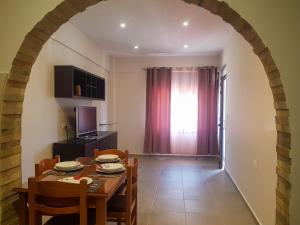 a kitchen and dining room with a table and chairs at SUNFLOWER in Agia Galini