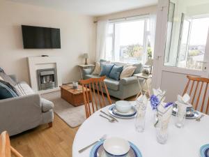 a living room with a table and a couch at Merlin in Kingsbridge