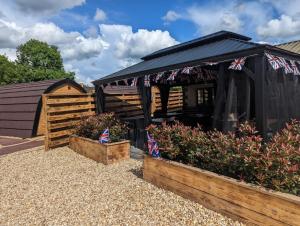 a black shed with british flags on it at Peacock Lake Glamping in Nottingham