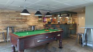 a room with a pool table and a bar at Peacock Lake Glamping in Nottingham +9 photos