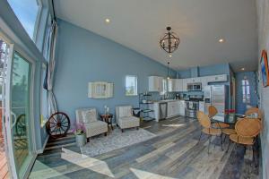 a kitchen and living room with blue walls at The Lighthouse in Homer