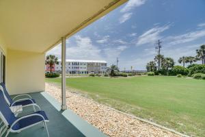 a porch with chairs and a large field of grass at Ciboney Condominiums by Panhandle Getaways in Destin