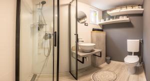 a bathroom with a shower with a toilet and a sink at LaraBella Salt fields view studio in Portorož