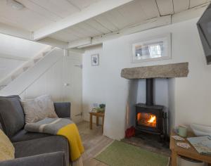 a living room with a couch and a fireplace at The Bakehouse in Port Isaac