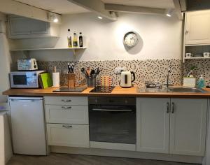 a kitchen with white cabinets and a counter top at The Bakehouse in Port Isaac
