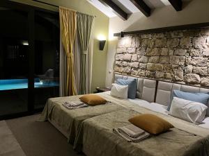 a bedroom with a large bed with pillows on it at Private Villa at BlackSeaRama Golf & Villas Resort in Balchik