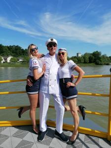 three people are posing for a picture on a boat at Hausboot MS Donautal in Neuhaus