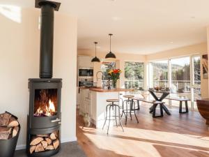 a kitchen and living room with a fireplace at Westertown in Strathdon