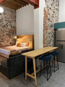 a bedroom with a bed and a desk and a table at 107 SUITES DONCELES CENTRO HISTÓRICO CDMX in Mexico City