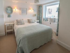 Llit o llits en una habitació de Mariners Cottage