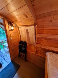 an inside view of a cabin with a chair in it at Little Ranch am Badesee in Urnshausen