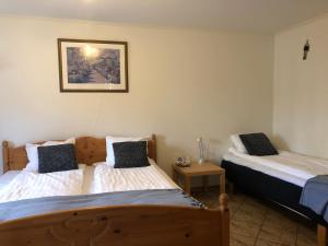 a bedroom with two beds and a night stand at Lägenhet i La Casa in Sölvesborg