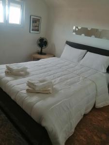 uma grande cama branca com duas toalhas em Duque de conventus em Lisboa