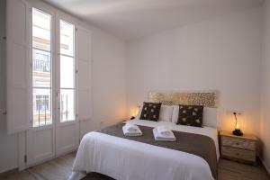 מיטה או מיטות בחדר ב-El Rincón de Fabio Little Apartments