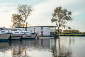 two boats docked in a marina in front of a building at Homeboat Glamping in Nieuwpoort